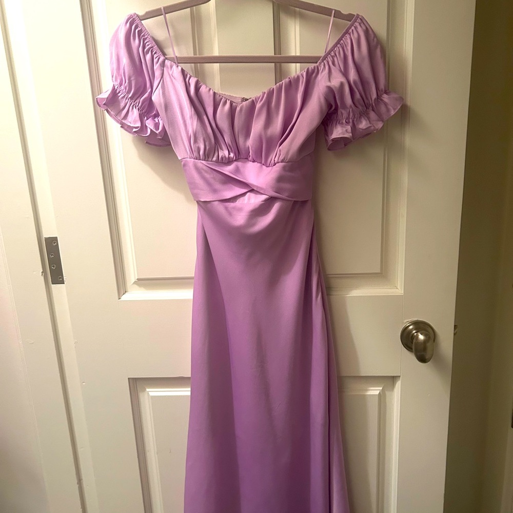 purple maxi dress with puff sleeves and a ties around the back